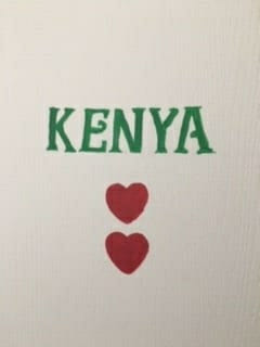 Image of a door with Kenya and 2 hearts painted on it.